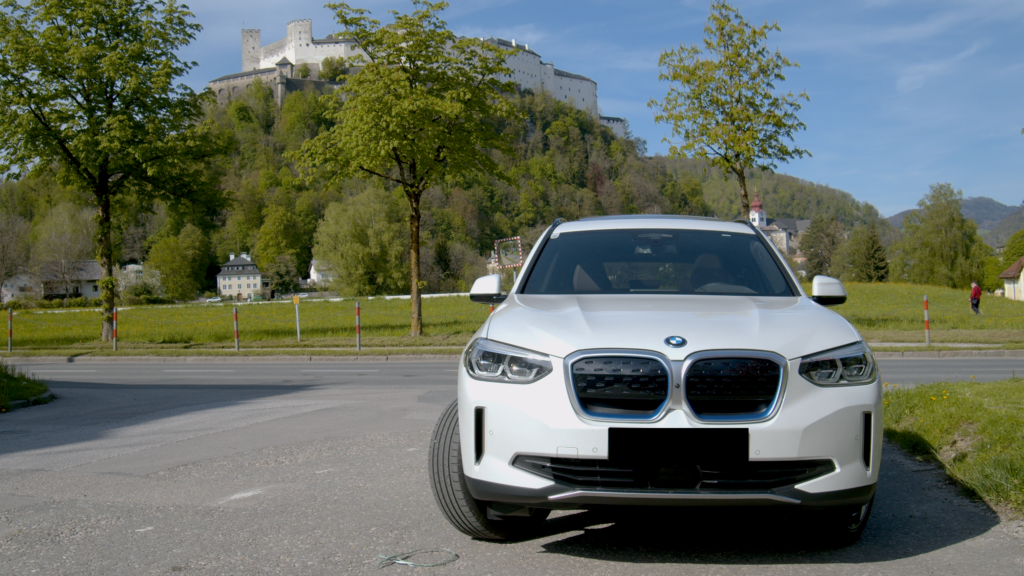 The 2021 model in front of Hohensalzburg Fortres in Austria - The BMW iX3 SUV in our EV-Test 